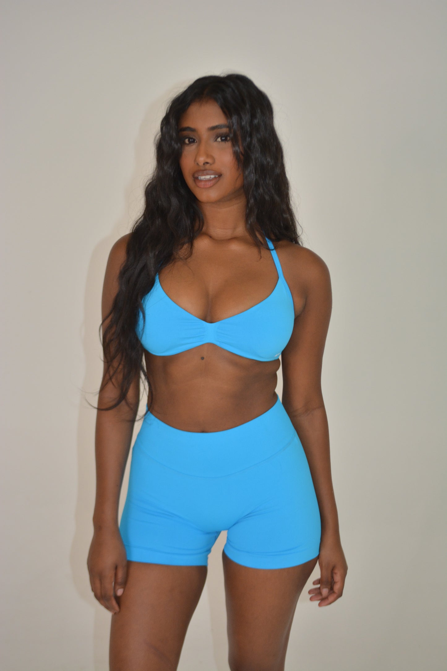 Person wearing a bright blue activewear set against a plain background
