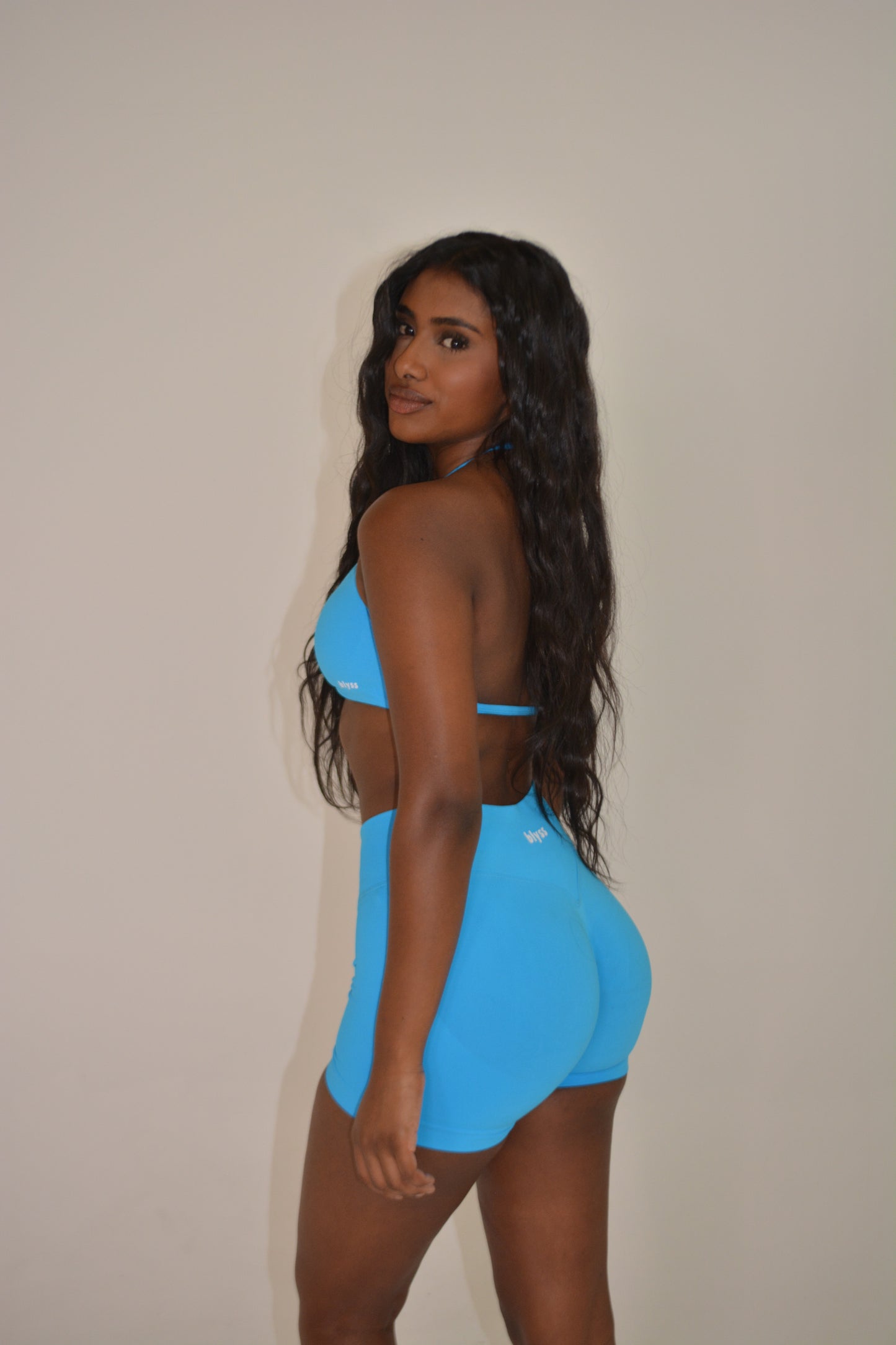 Person wearing a bright blue activewear set against a plain background