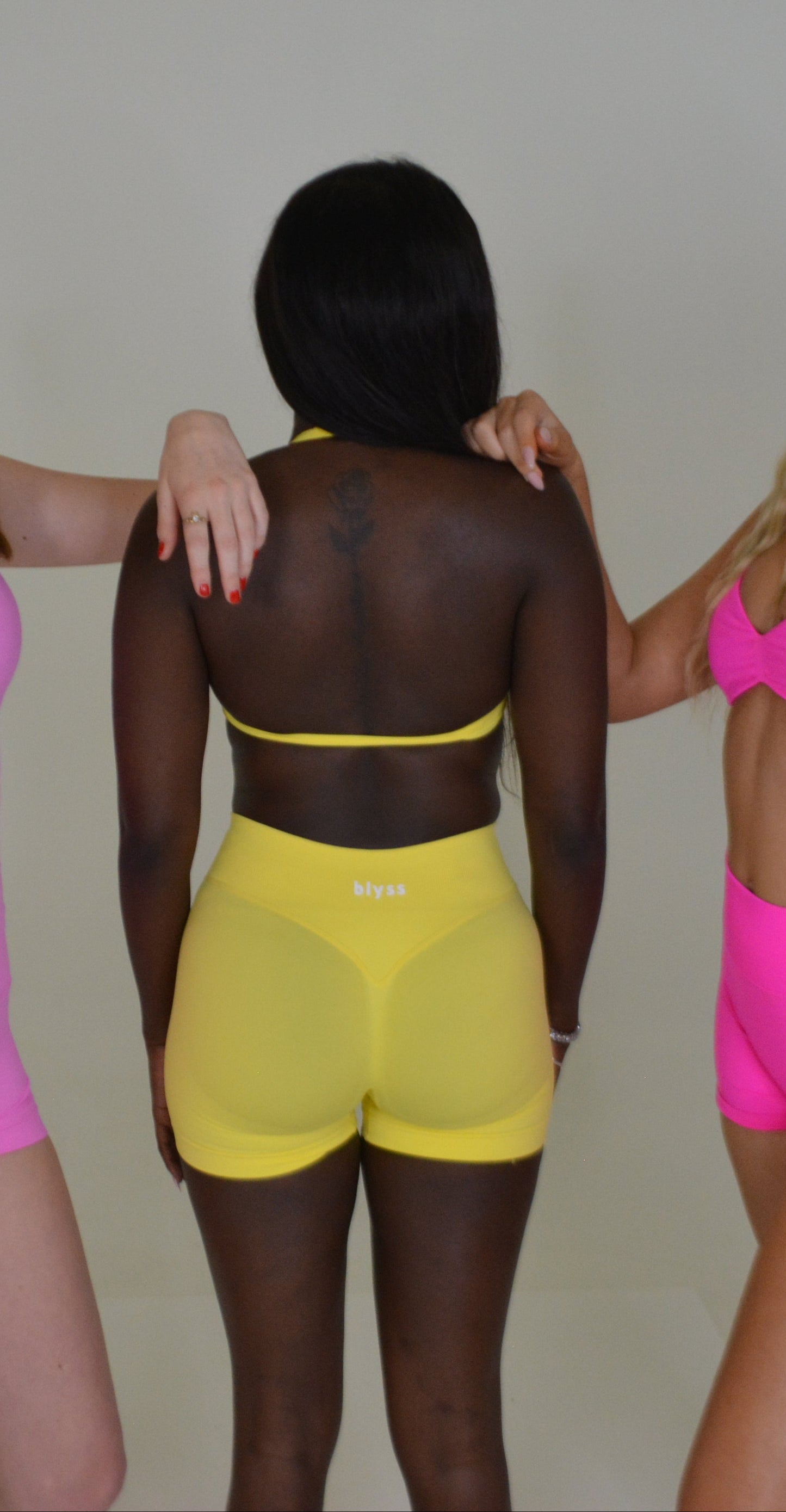 Person wearing a bright yellow activewear set against a plain background