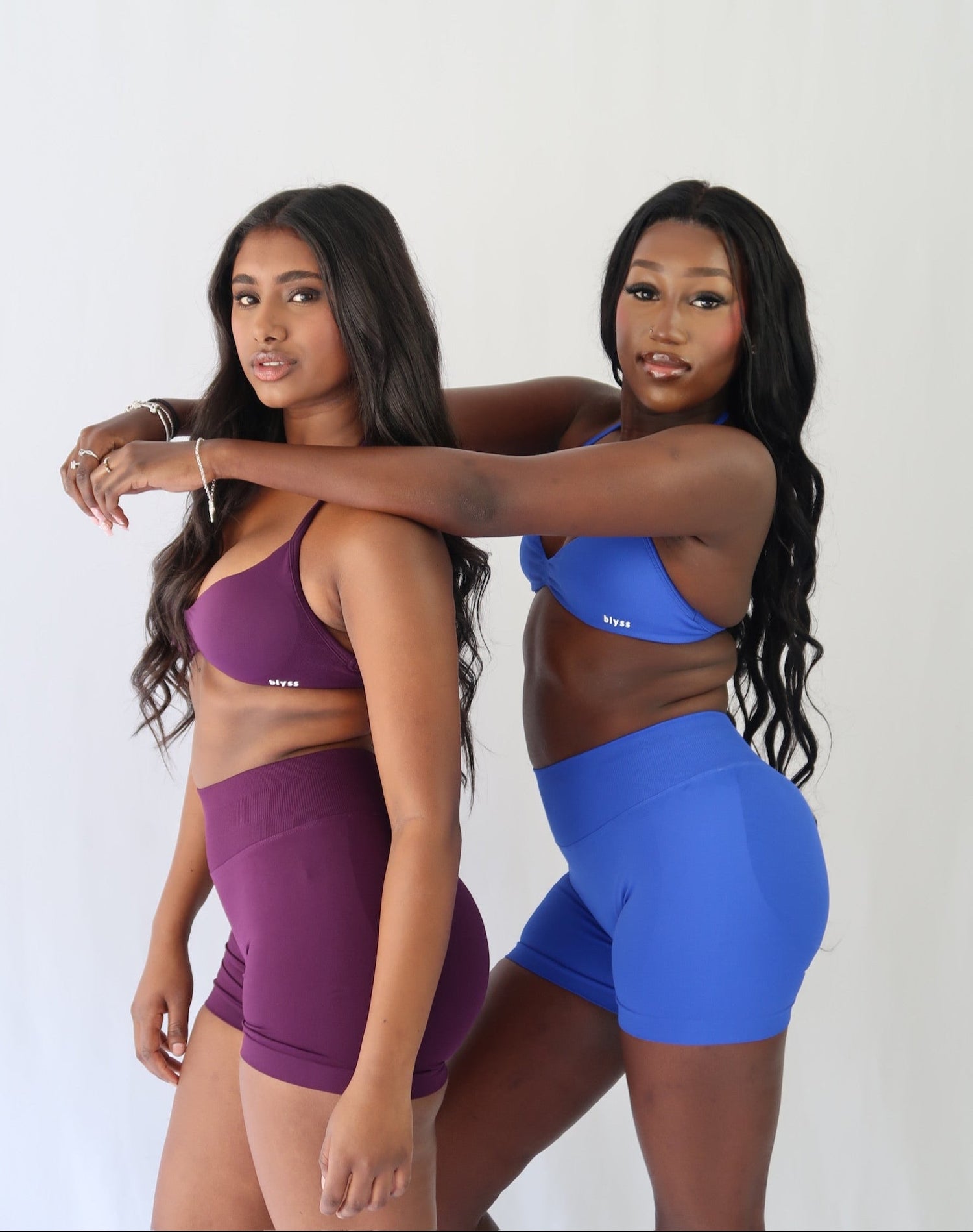 Two models wearing Ignite collection in Deep grape and Royal Blue on a white background